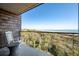 Oceanfront balcony featuring outdoor seating with views of lush vegetation, beach and ocean at 2473 Shipwatch Rd, Kiawah Island, SC 29455