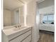 Bright bathroom with a modern vanity and view into bedroom and balcony at 2473 Shipwatch Rd, Kiawah Island, SC 29455