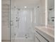 Modern bathroom featuring white tile, glass shower, and sleek vanity at 2473 Shipwatch Rd, Kiawah Island, SC 29455