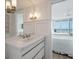 Bright bathroom featuring a white vanity with stainless steel fixtures and a glimpse into the bedroom at 2473 Shipwatch Rd, Kiawah Island, SC 29455