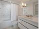 Modern bathroom featuring marble tile, a shower-tub, and a sleek vanity at 2473 Shipwatch Rd, Kiawah Island, SC 29455