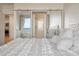 Bright bedroom showcasing white bedding with balcony access and view at 2473 Shipwatch Rd, Kiawah Island, SC 29455