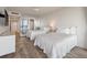 Bright bedroom with two beds, mirrored wall, and balcony access at 2473 Shipwatch Rd, Kiawah Island, SC 29455