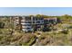 Exterior shot of a multi-story condo complex surrounded by tropical greenery and access boardwalks at 2473 Shipwatch Rd, Kiawah Island, SC 29455