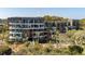 A multi-story condo complex with balconies, lush greenery and tropical palm trees at 2473 Shipwatch Rd, Kiawah Island, SC 29455