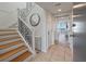 Inviting entryway featuring wood stairs, decorative mirror, and beach view at 2473 Shipwatch Rd, Kiawah Island, SC 29455