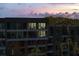 A luxury condo complex is beautifully illuminated in a sunset view, showcasing private outdoor spaces at 2473 Shipwatch Rd, Kiawah Island, SC 29455