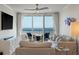 Bright living room featuring a large window with ocean views and cozy, stylish furniture at 2473 Shipwatch Rd, Kiawah Island, SC 29455