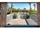 Outdoor wooden walkway that is surrounded by palm trees and manicured greenery at 2473 Shipwatch Rd, Kiawah Island, SC 29455