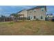 Spacious back yard featuring a covered swing set, fire pit, and patio sitting area at 252 Swamp Creek Ln, Moncks Corner, SC 29461