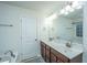 Bathroom with double sinks, a bathtub, and a large mirror above the vanity at 252 Swamp Creek Ln, Moncks Corner, SC 29461