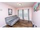 Bedroom with light pink walls, a grey futon, laminate floors, and lots of natural light at 252 Swamp Creek Ln, Moncks Corner, SC 29461