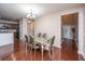Bright dining room with modern chandelier and glass-topped table adjacent to the kitchen and entrance foyer at 252 Swamp Creek Ln, Moncks Corner, SC 29461