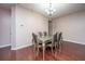 Well-lit dining room features a modern chandelier and a glass-topped dining table with seating for six at 252 Swamp Creek Ln, Moncks Corner, SC 29461