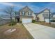 Attractive two-story home with a two-car garage and a long driveway, framed by a well-maintained lawn and landscaping at 252 Swamp Creek Ln, Moncks Corner, SC 29461