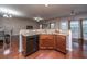 Kitchen bar featuring granite countertops, dark cabinetry, a stainless steel dishwasher, and an open view to the living area at 252 Swamp Creek Ln, Moncks Corner, SC 29461