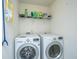Bright laundry room with a washer, dryer, and shelf for storage at 252 Swamp Creek Ln, Moncks Corner, SC 29461