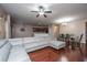Spacious living room featuring cherry hardwood floors, a large sectional sofa, and an open layout to the kitchen and dining area at 252 Swamp Creek Ln, Moncks Corner, SC 29461