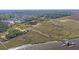 Expansive aerial view showcasing a dock, kayaks, and waterway with serene waterfront community access and amenities at 2710 Mcfadden Way, Johns Island, SC 29455