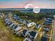 Aerial view of a community near the Stono River with similar home styles and manicured lawns at 2710 Mcfadden Way, Johns Island, SC 29455