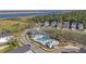 Beautiful aerial view of a community with well-maintained landscaping, pool, and water views at 2710 Mcfadden Way, Johns Island, SC 29455