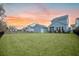Large grassy backyard with privacy fence and blue siding home in the background at 2710 Mcfadden Way, Johns Island, SC 29455