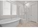 Bright bathroom featuring a glass-enclosed shower and free-standing tub at 2710 Mcfadden Way, Johns Island, SC 29455
