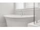 Close-up of a modern white bathtub with elegant fixtures and natural light at 2710 Mcfadden Way, Johns Island, SC 29455