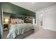 Comfortable bedroom with colorful accent wall, stylish shelving, and easy access to a full bathroom at 2710 Mcfadden Way, Johns Island, SC 29455