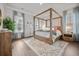 Serene main bedroom with a four-poster bed, rug, and natural light at 2710 Mcfadden Way, Johns Island, SC 29455