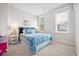 Bright bedroom features a blue bed, white walls, and ample natural light at 2710 Mcfadden Way, Johns Island, SC 29455