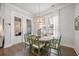 Dining room featuring a round wooden table, green chairs, chandelier, and window with sheer curtains at 2710 Mcfadden Way, Johns Island, SC 29455