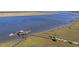 Scenic aerial view of dock with a gazebo, boat lifts, and kayaks on the shoreline, set against tranquil waters at 2710 Mcfadden Way, Johns Island, SC 29455