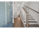 Bright entryway with hardwood floors, a staircase with wooden railings, and views into the dining room at 2710 Mcfadden Way, Johns Island, SC 29455