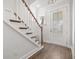 Entryway with hardwood floors, a staircase with wooden railings, and natural light from the front door at 2710 Mcfadden Way, Johns Island, SC 29455