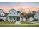 Charming two-story home with a welcoming front porch, manicured lawn, and detached garage at 2710 Mcfadden Way, Johns Island, SC 29455