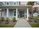 Inviting front porch with classic white columns and manicured landscaping, and a detached garage at 2710 Mcfadden Way, Johns Island, SC 29455