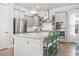 Bright kitchen features stainless appliances, shaker cabinets, white backsplash, and island with seating at 2710 Mcfadden Way, Johns Island, SC 29455