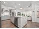 Bright kitchen features stainless appliances, shaker cabinets, white backsplash, and an island with seating at 2710 Mcfadden Way, Johns Island, SC 29455