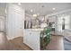 Bright kitchen features stainless appliances, shaker cabinets, white backsplash, and an island with seating at 2710 Mcfadden Way, Johns Island, SC 29455