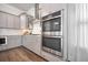 Kitchen features stainless appliances, shaker cabinets, white backsplash, with double oven and modern lighting at 2710 Mcfadden Way, Johns Island, SC 29455