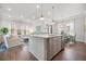 Bright kitchen features stainless appliances, shaker cabinets, white backsplash, and island with seating at 2710 Mcfadden Way, Johns Island, SC 29455