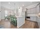 Bright kitchen features stainless appliances, shaker cabinets, white backsplash, island with seating, and hardwood floors at 2710 Mcfadden Way, Johns Island, SC 29455