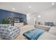 Stylish living room with a blue accent wall, comfortable seating, and modern decor at 2710 Mcfadden Way, Johns Island, SC 29455