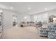 Bright living room features a large sectional sofa, stylish rug, and ample natural light at 2710 Mcfadden Way, Johns Island, SC 29455