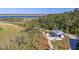 Aerial view of a waterfront pavilion with outdoor seating, surrounded by lush greenery and a scenic view at 2710 Mcfadden Way, Johns Island, SC 29455