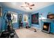 Bedroom with blue walls, a ceiling fan, natural light, and exercise equipment at 29 Meander Row, Charleston, SC 29412