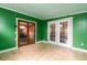 Bright sun room with tiled floor, green walls, and two sets of glass doors leading to the exterior at 29 Meander Row, Charleston, SC 29412