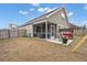 Backyard view of the home featuring a screened-in patio and exterior with a well maintained lawn at 319 Knawl Rd, Moncks Corner, SC 29461