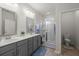 Clean bathroom with dual sinks, a glass-enclosed shower, and a toilet at 319 Knawl Rd, Moncks Corner, SC 29461